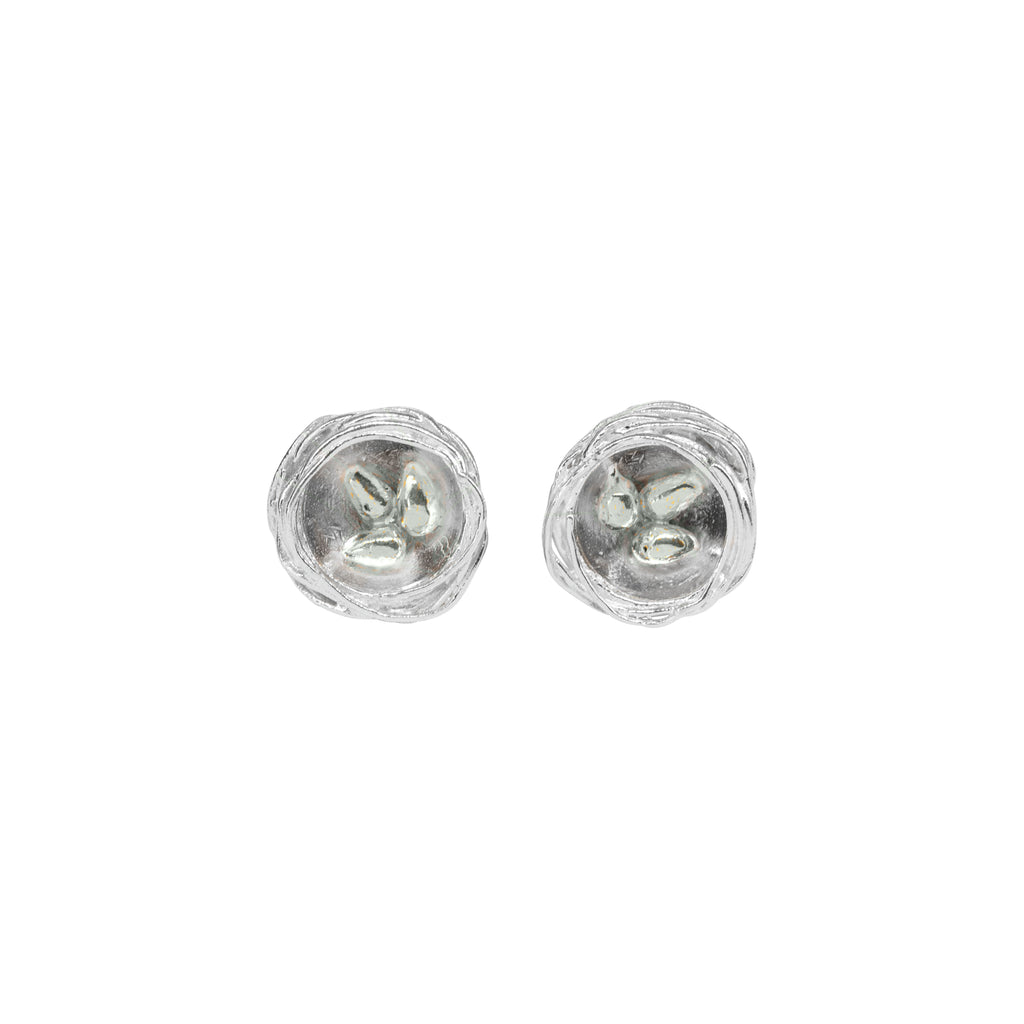 A pair of round textured silver nest style studs with three silver tiny eggs in each