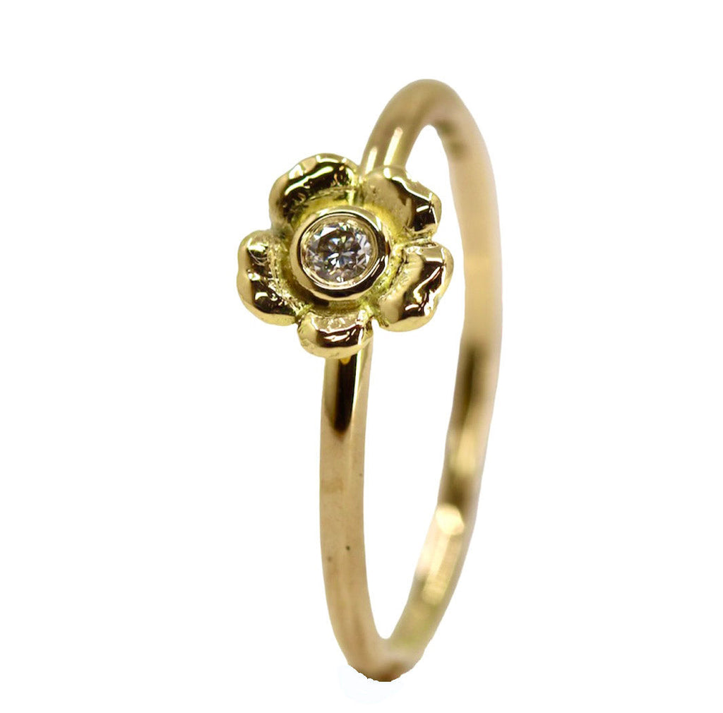 yellow gold ring with diamond set inside flower head