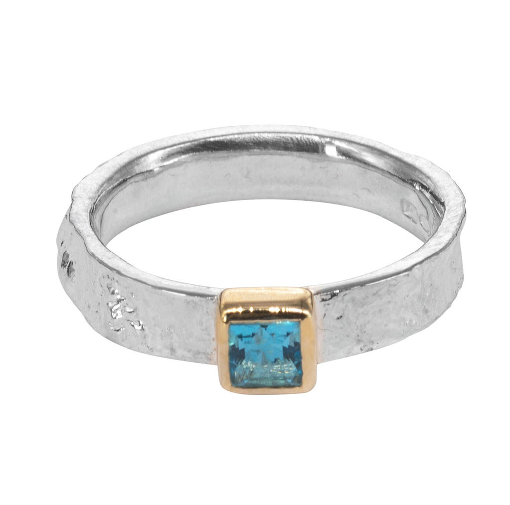 Textured silver ring with square blue stone in gold setting