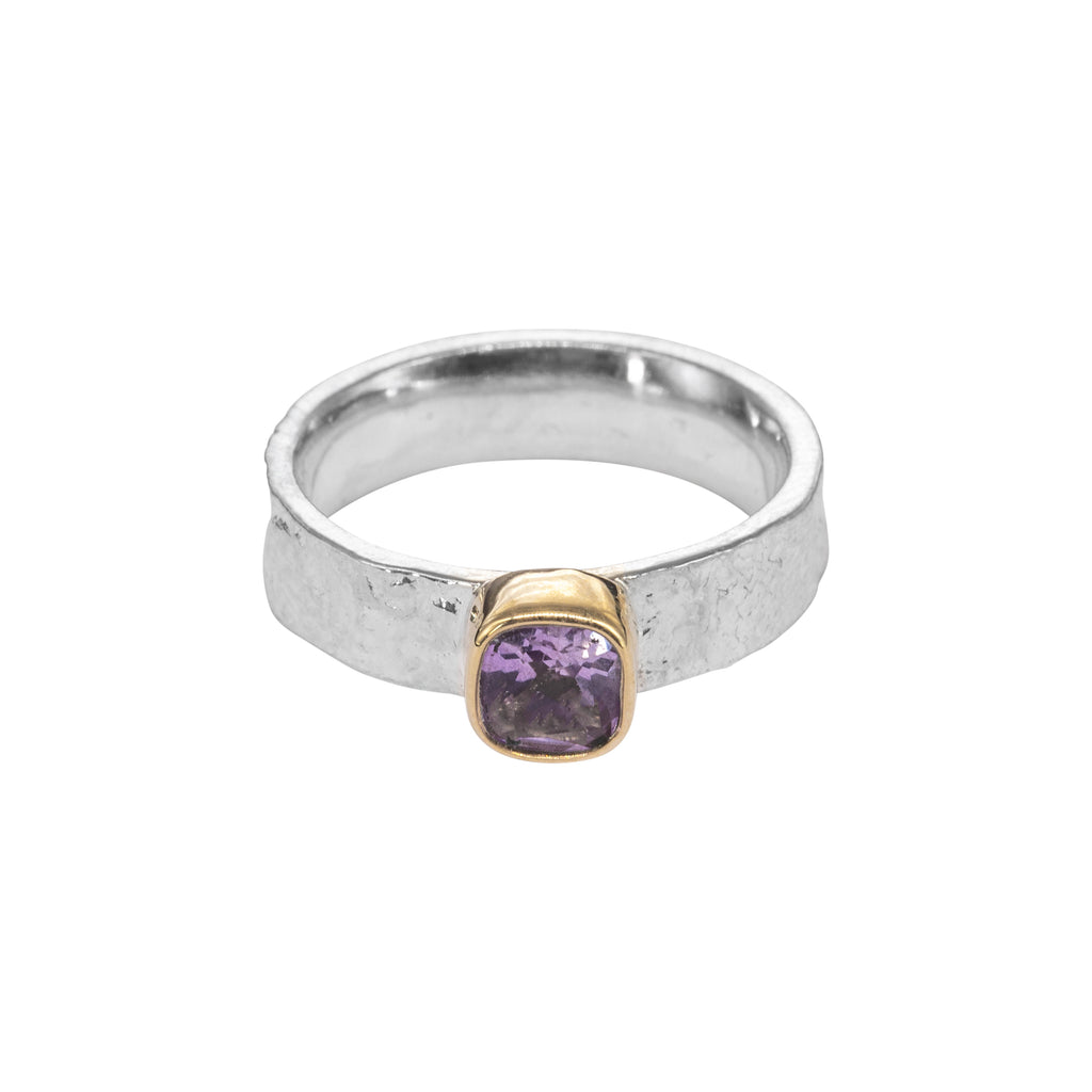 textured silver ring with gold bezel holding a cushion amethyst