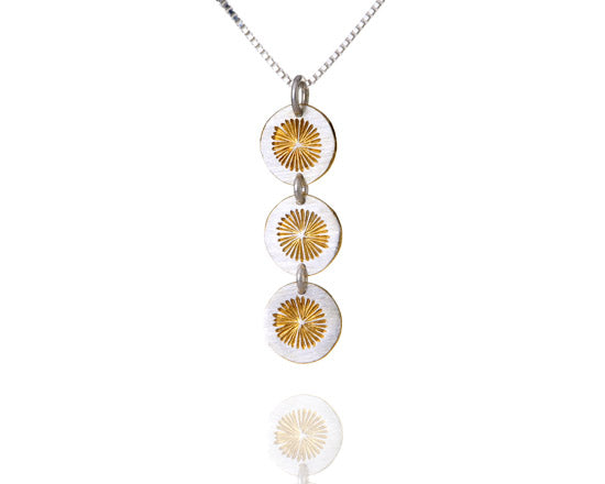 silver necklace with 3 gold suns