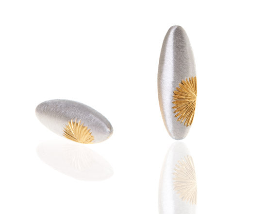Oval silver earrings with gold sunrise pattern to the side