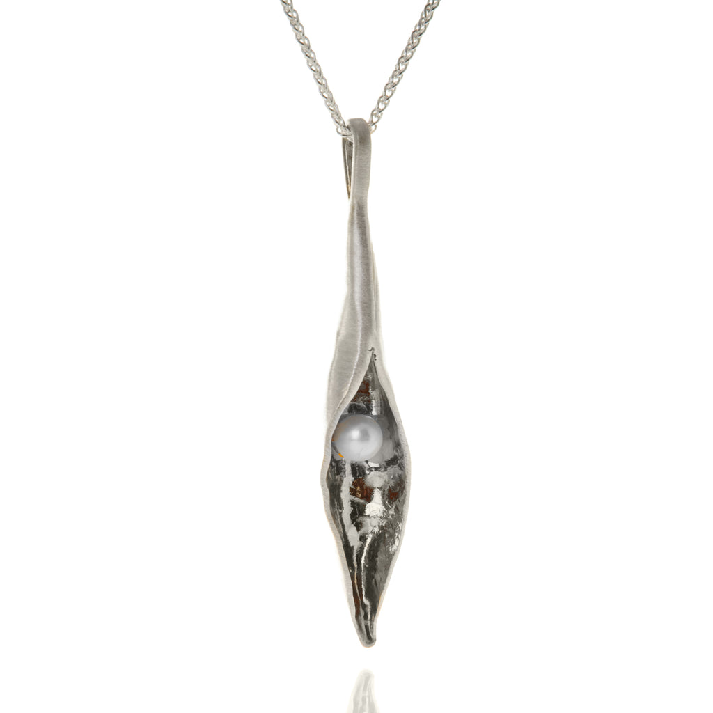 Long silver pod pendant with white pearl inside, on silver chain