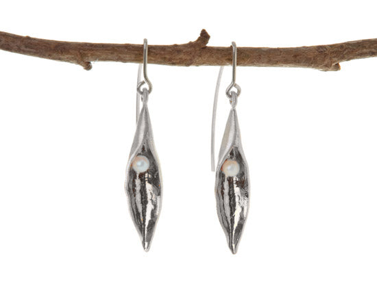 Medium silver pea pod earrings with white pearl hanging on a branch