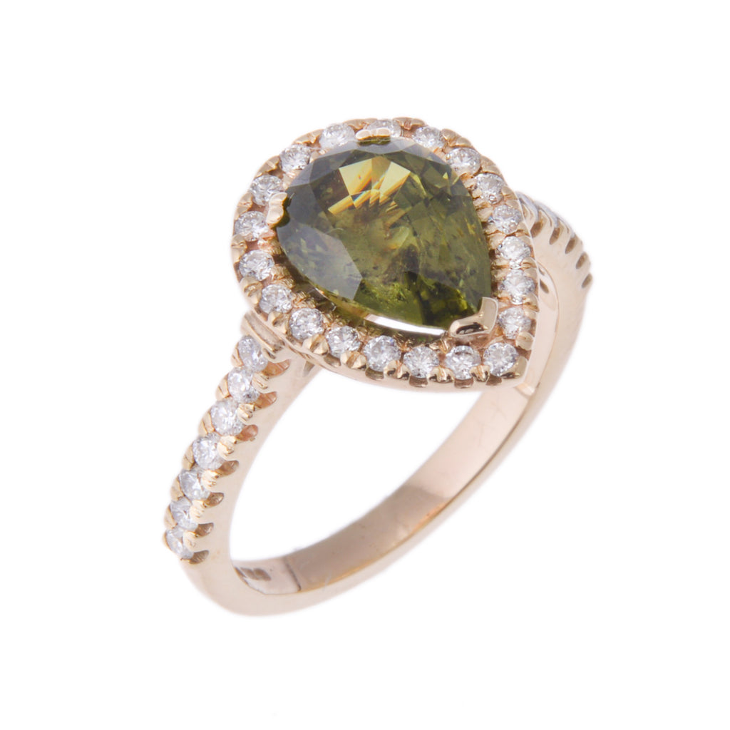 Pear shaped green sapphire ring with diamonds all around the sapphire and along the shoulders