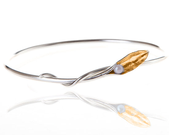 silver bangle with white pearl in gold pod