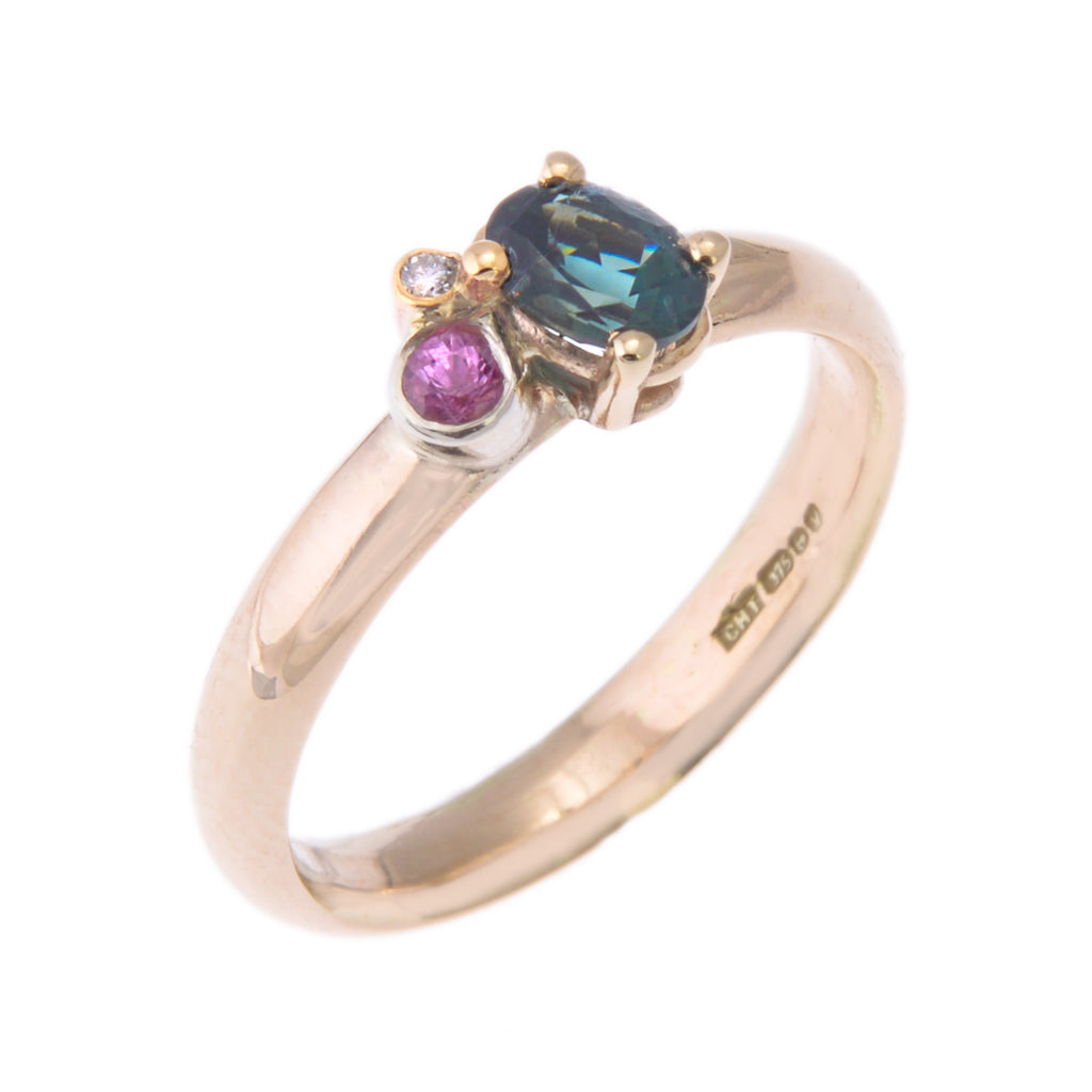 Gold ring with teal oval sapphire, pink sapphire and diamond in a cluster