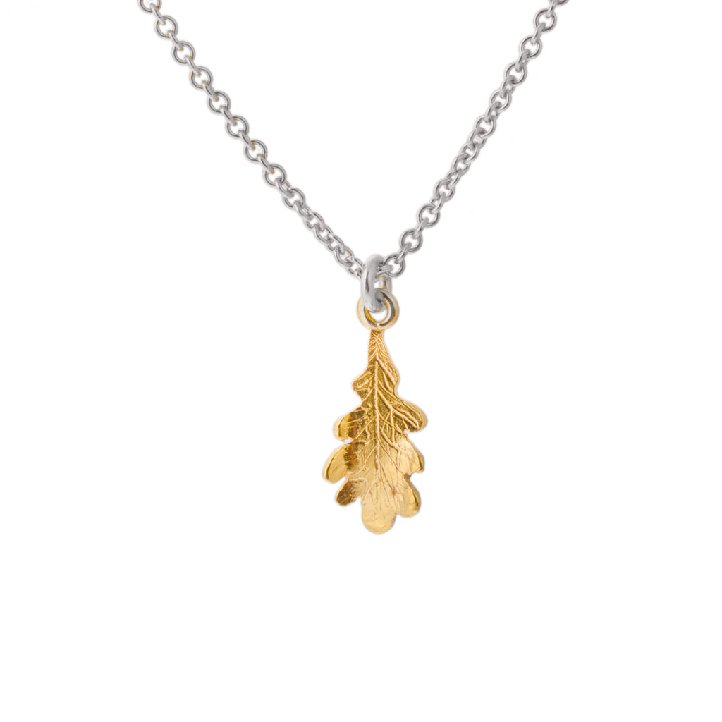 Tiny gold oak leaf pendant on silver chain