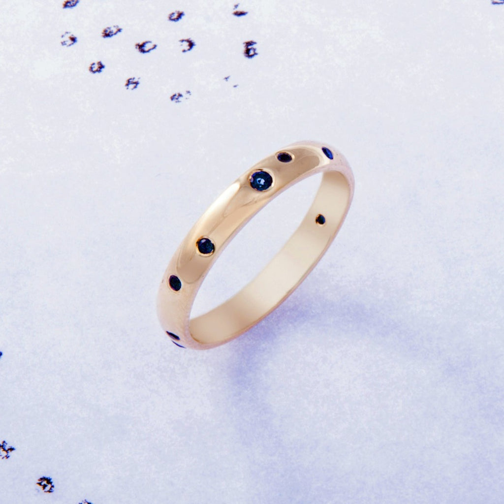 Yellow gold ring with blue sapphires set into the surface