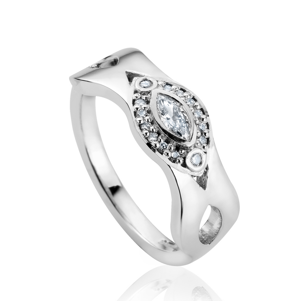 Chunky white gold ring with wavey edges and marquise diamond set in the centre of a halo of round diamonds