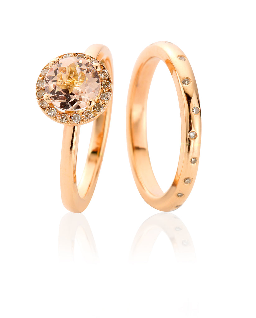 On the left is a rose gold engagement ring with large central morganite surrounded by a diamond halo. On the right is a matching rose gold wedding ring flush set with scattered diamonds
