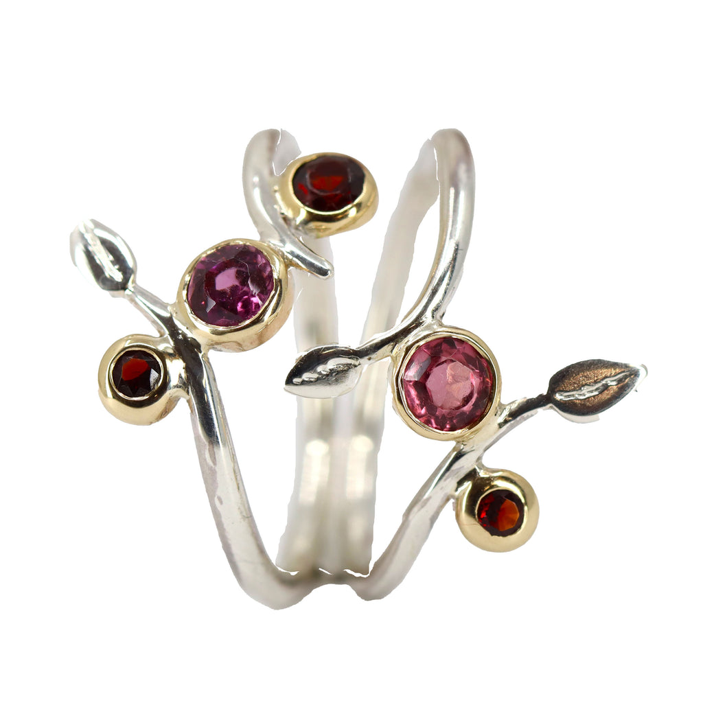 Two silver wire rings with pink stones set in gold bezels