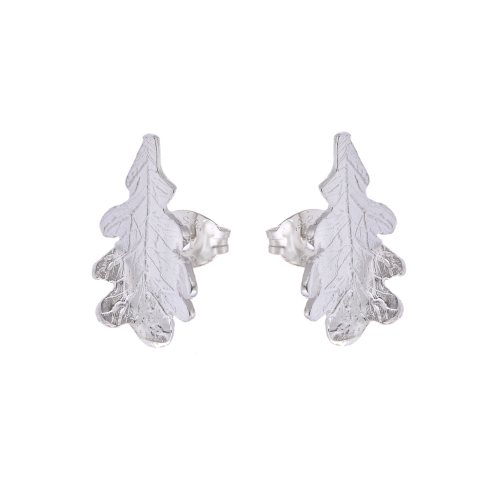 A pair of silver stud earrings in the shape of an oak leaf with engraved vein patterns