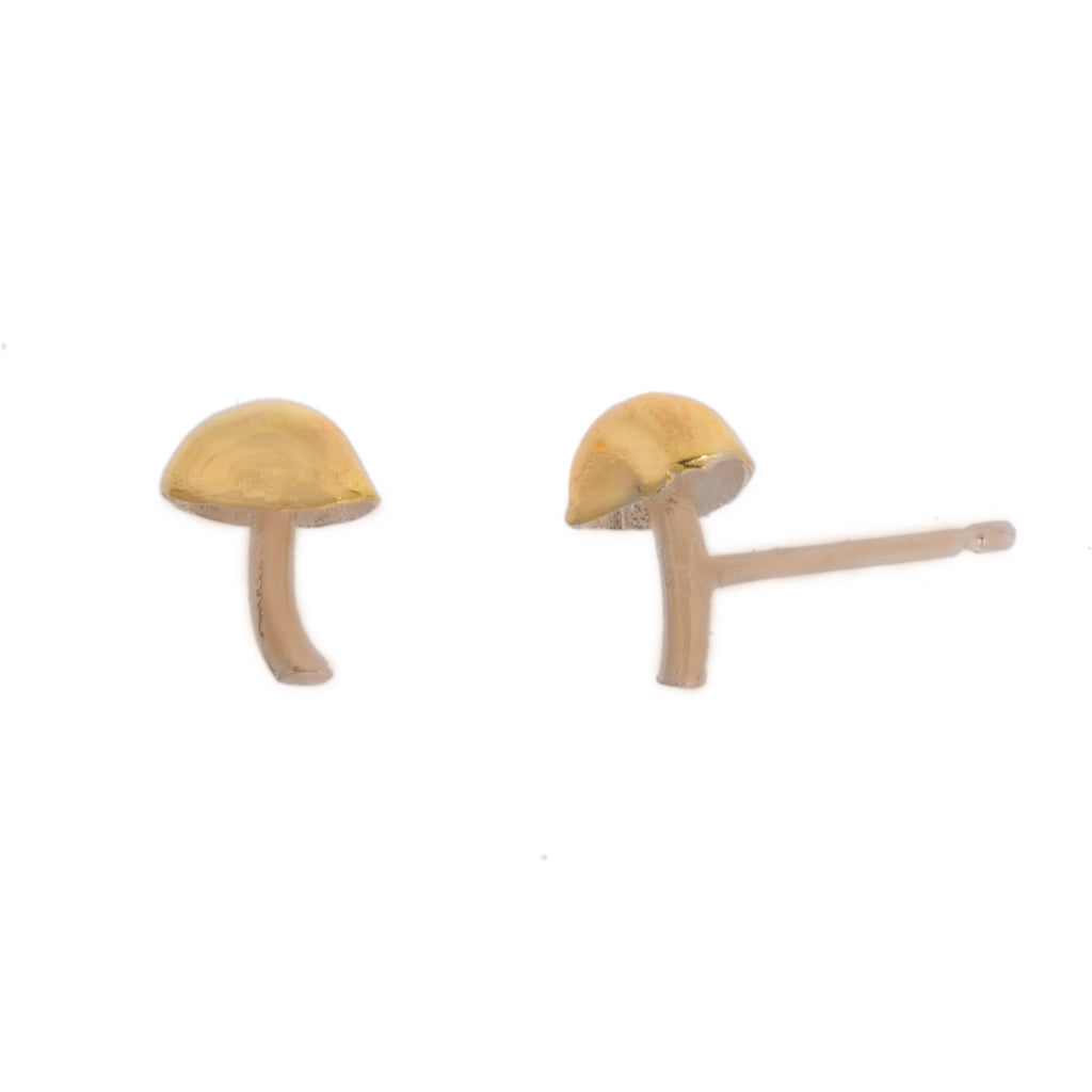 Tiny gold mushroom studs with earring post showing on the right hand side