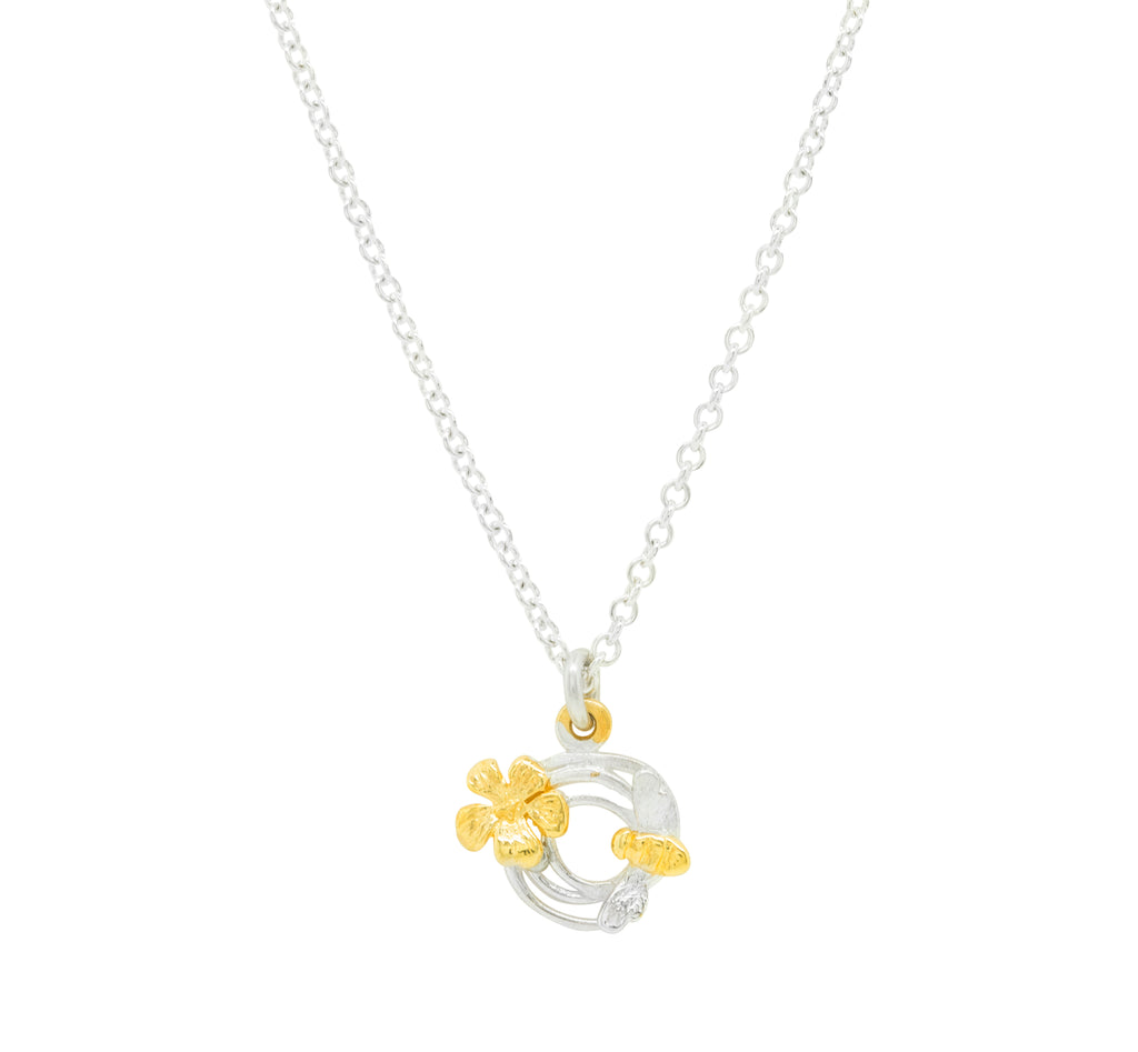 small swirl silver necklace with gold bee and flower