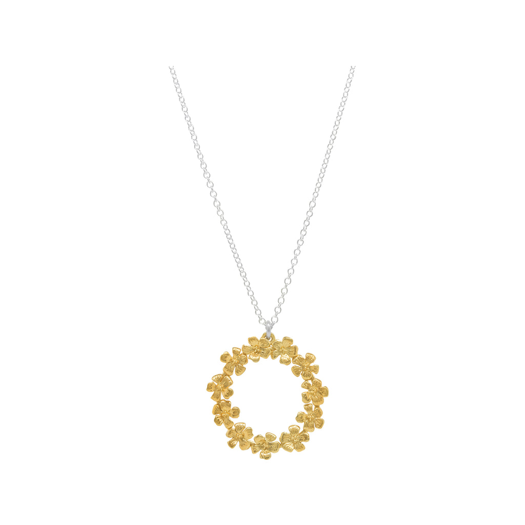 gold circle of flowers pendant on silver chain