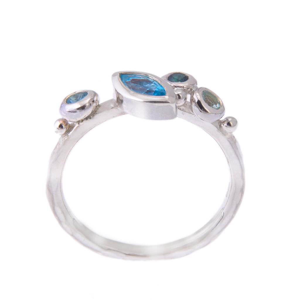 Silver ring with marquise blue stone and 3 round stones seen from the side