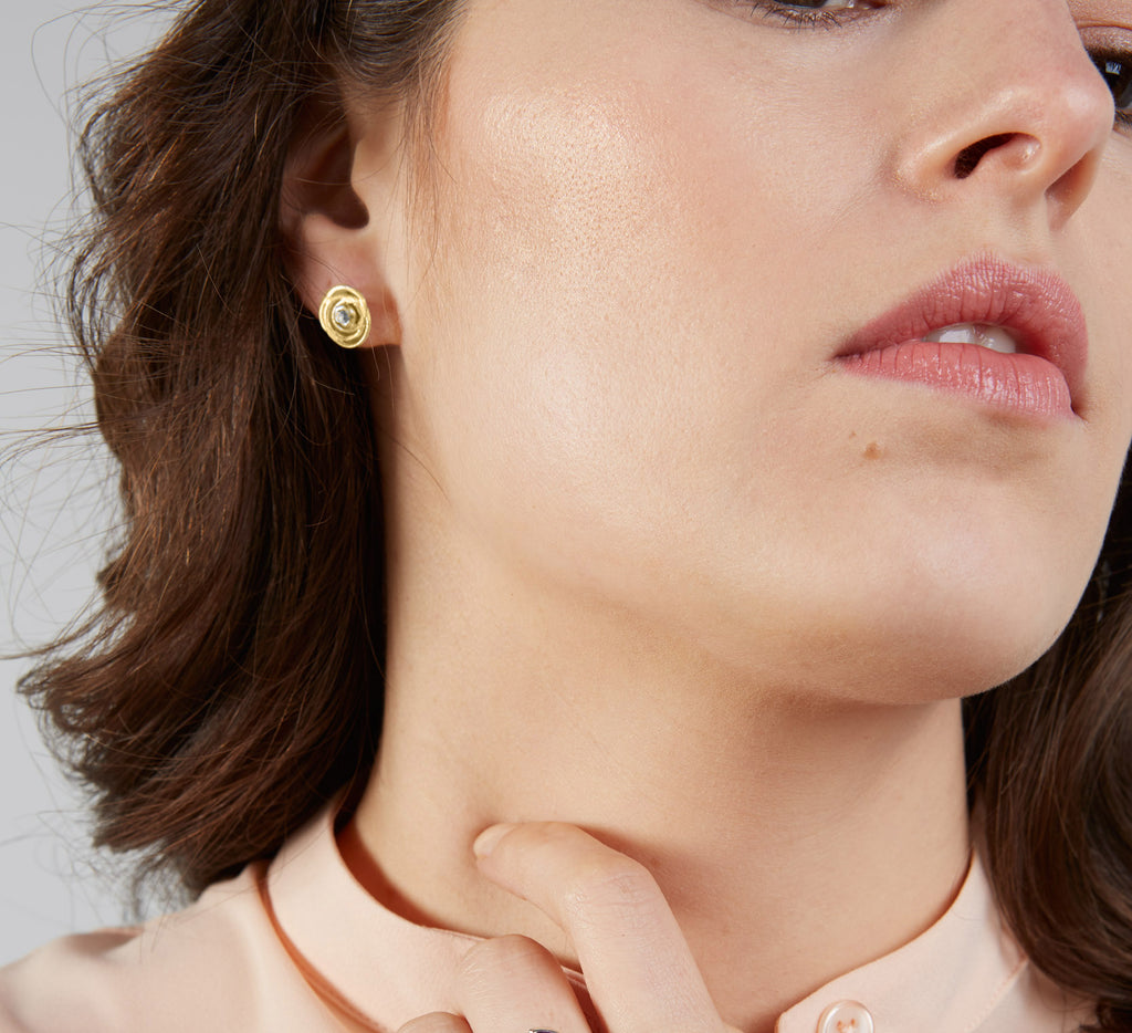 model wearing 18ct skimming stones earrings