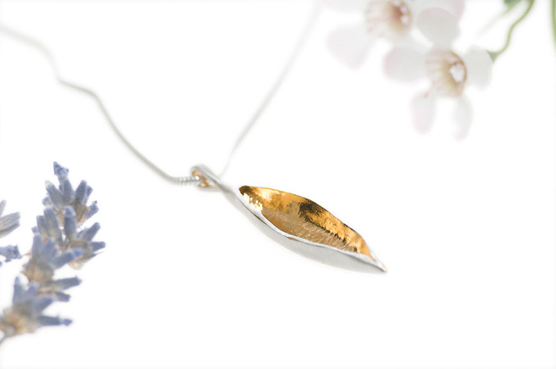 large silver and gold leaf necklace on silver chain