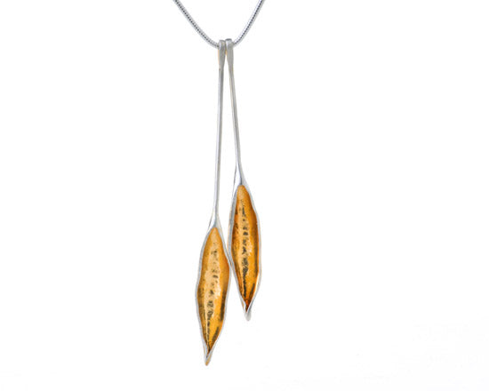 2 long silver and gold pod pendants on chain