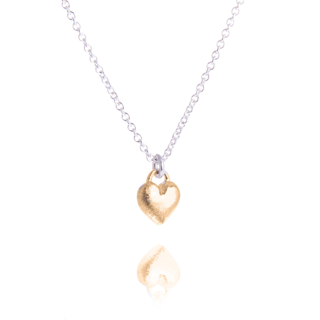 small gold rouned heart pendant on silver trace chain