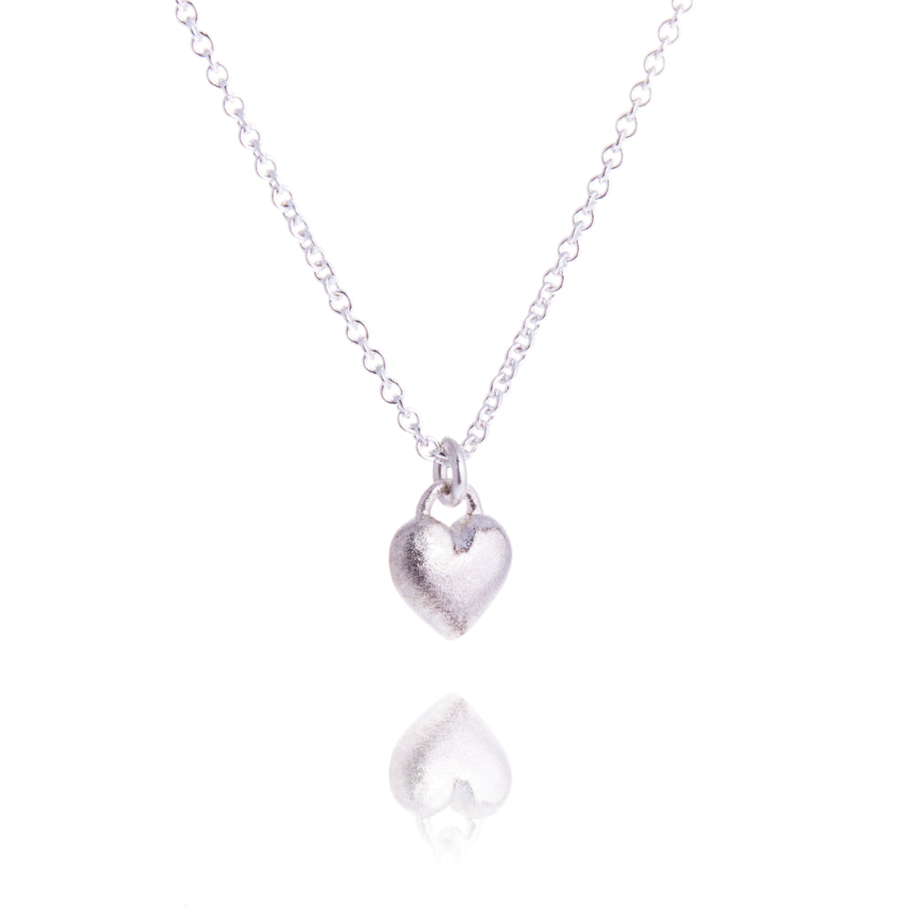 small rounded heart pendant on silver trace chain
