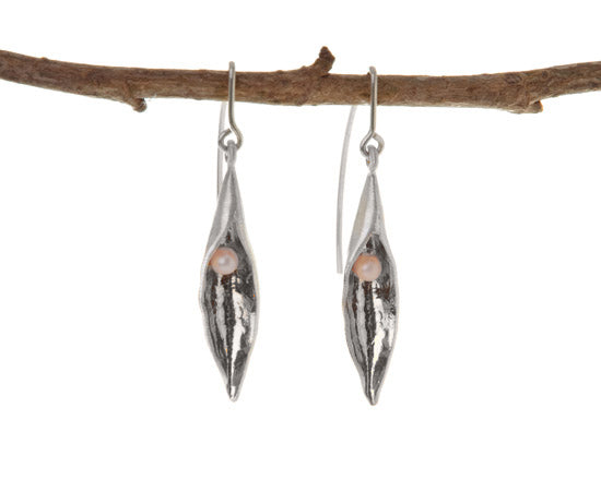 Medium pea pod earrings with pink pearl inside. The hooks fittings are looped over a twig