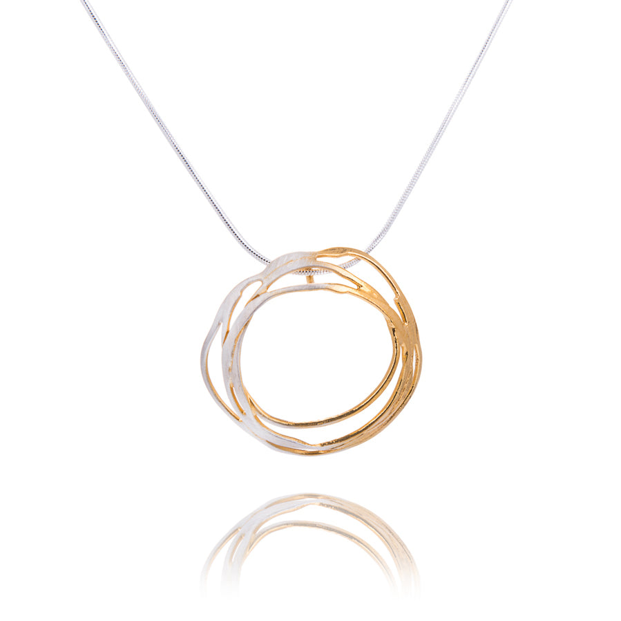 Half silver and half gold circular swirly pendant on silver chain