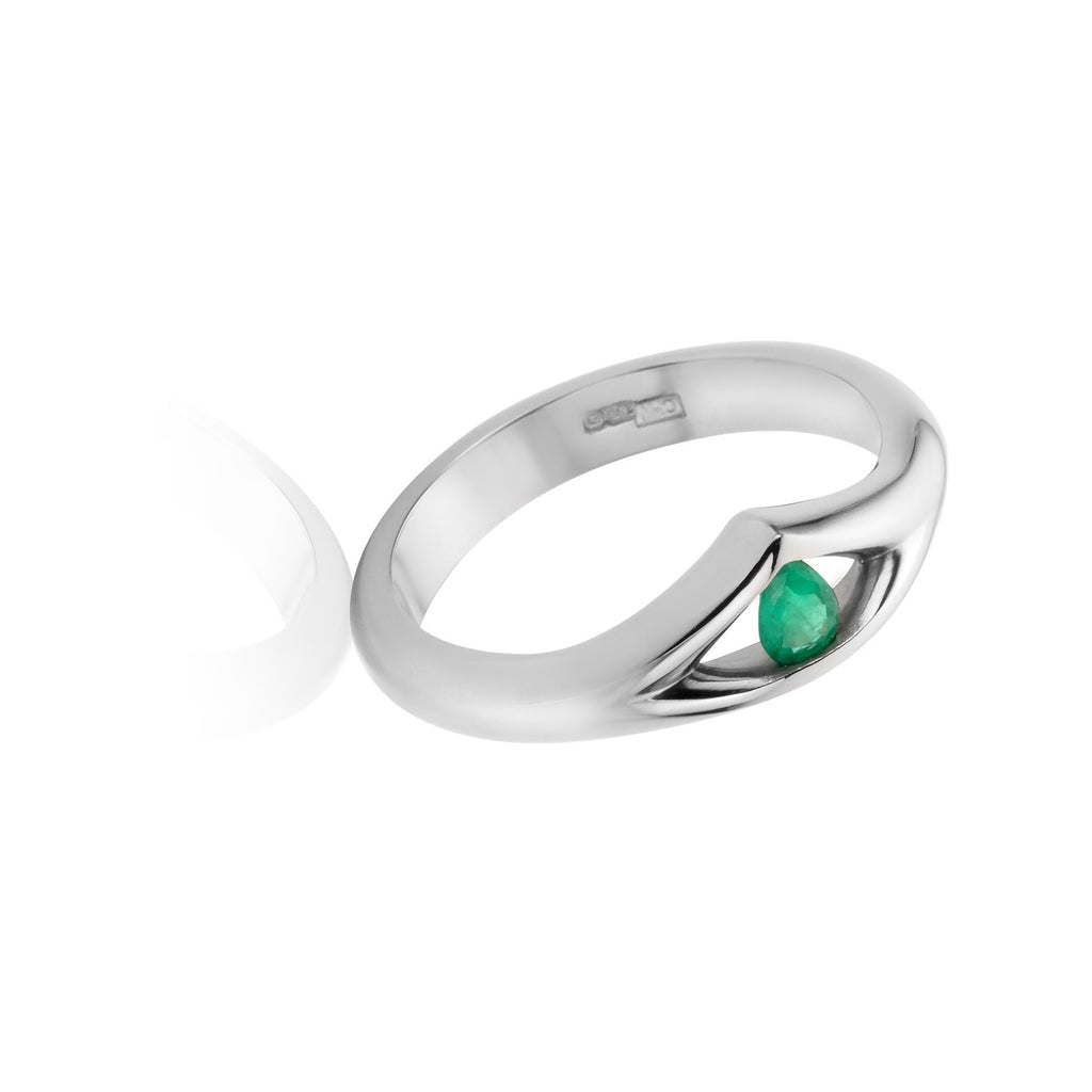 mountain style engagement ring in 18ct white gold with a pear shaped emerald inside a cut out