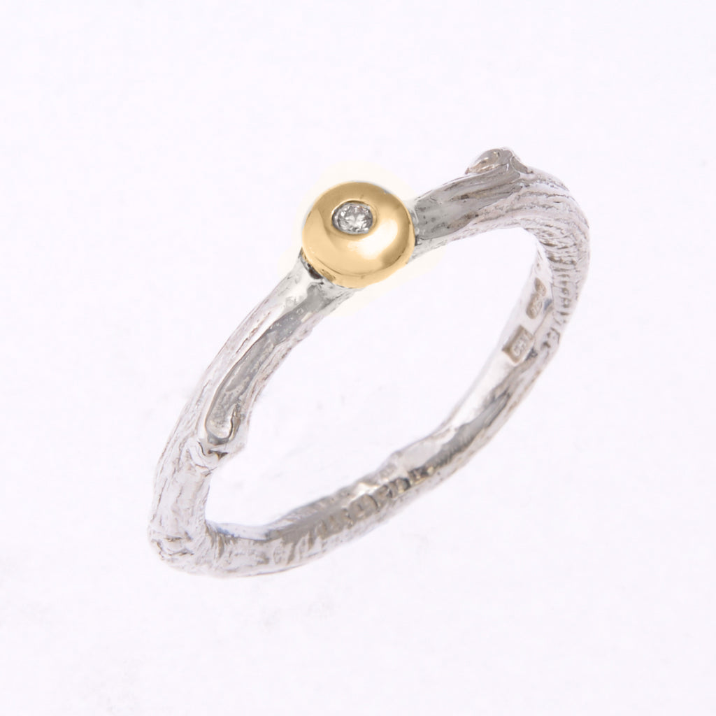 Silver twig ring with diamond set in gold pebble