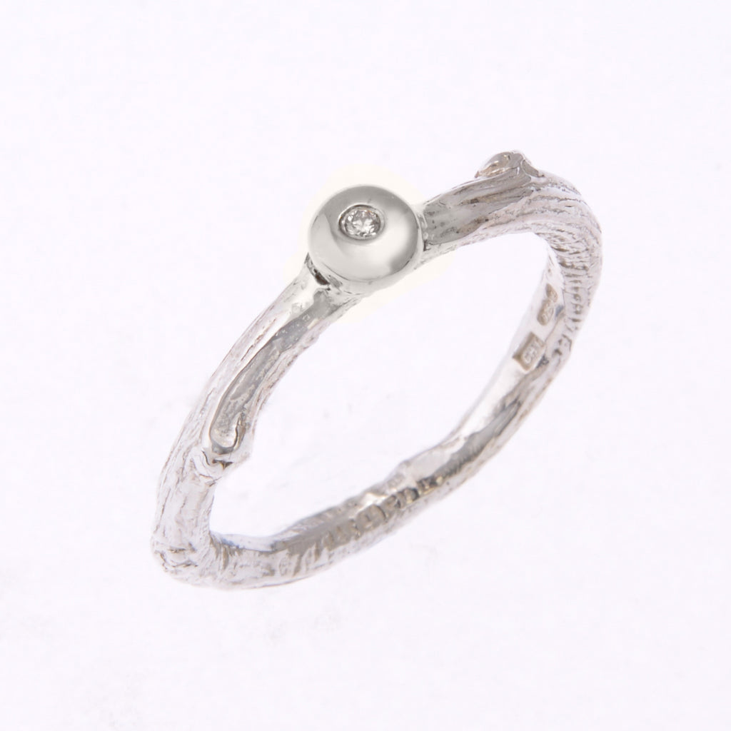 silver twig ring with diamond set in silver bud
