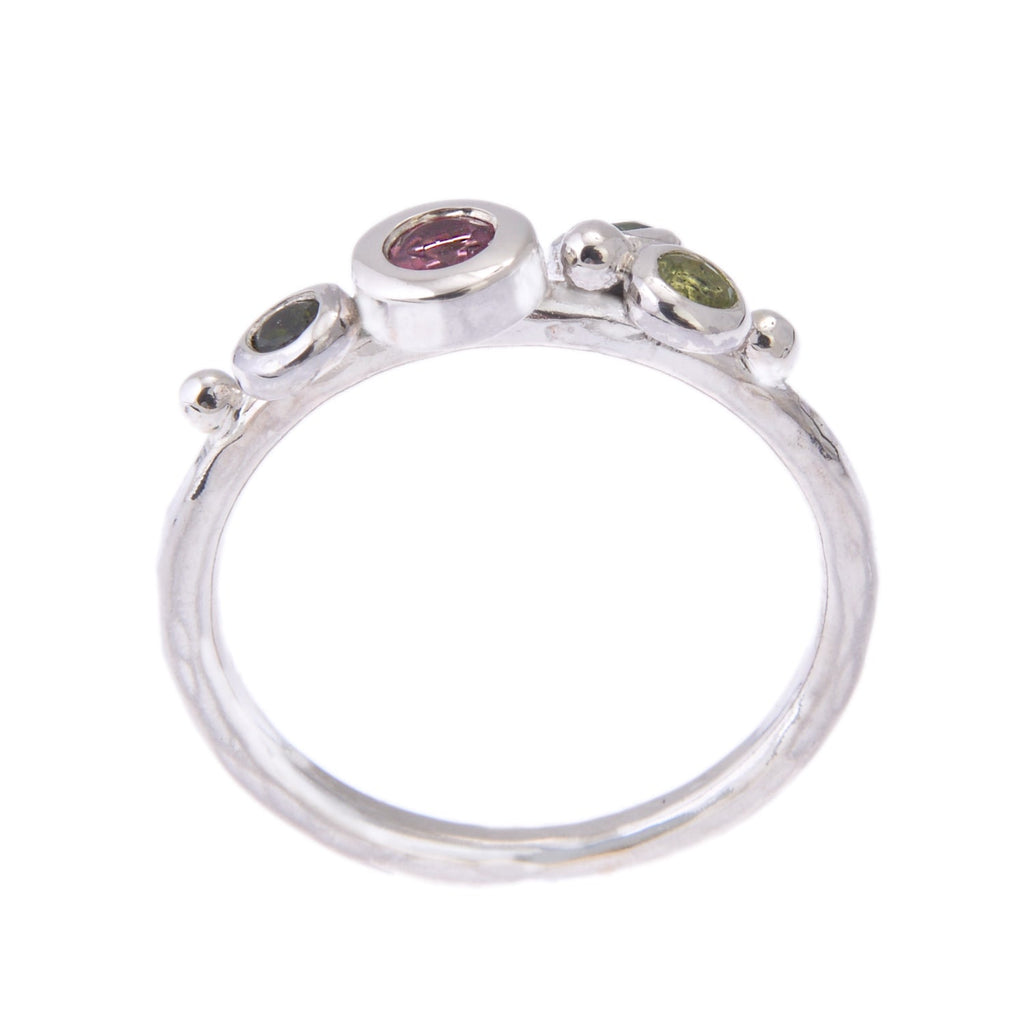 side view of silver Enchanted Spring Bud ring with pink and green gemstones
