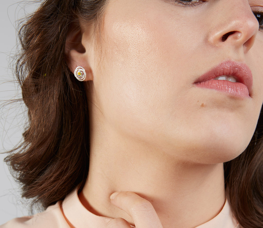 lady wearing small silver earrings with citrine in centre