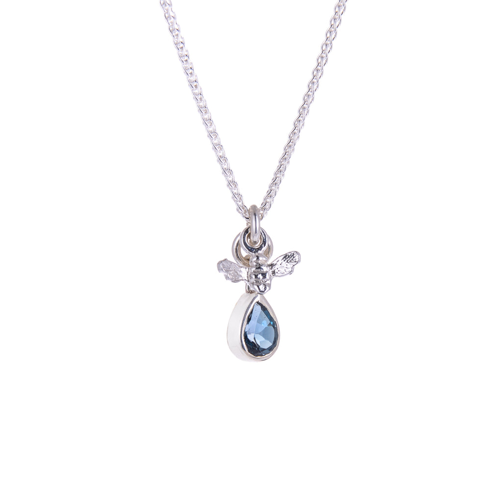 Tiny silver bee pendant with pear shaped blue gemstone hanging beneath it on silver chain