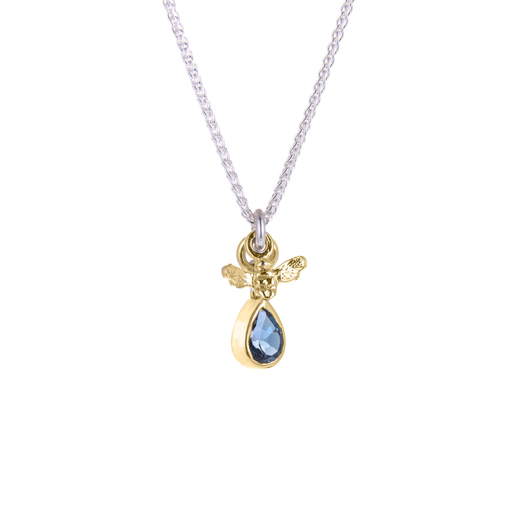 Tiny gold bee pendant with blue gemstone in gold pendant on silver chain