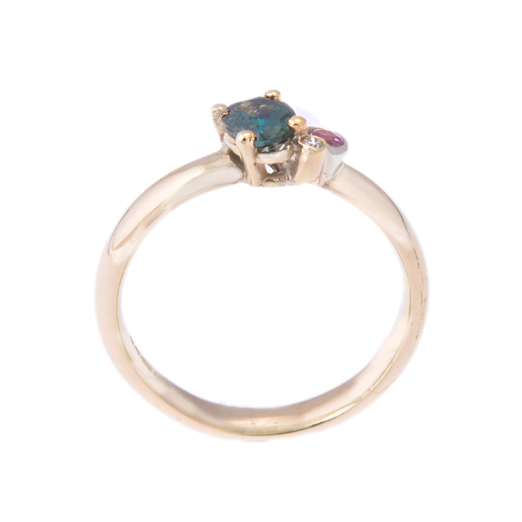 Gold ring with teal pink and white gemstones side view